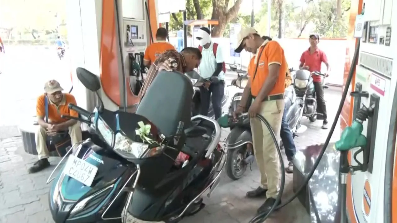People filling petrol at a pump in Bhopal.
