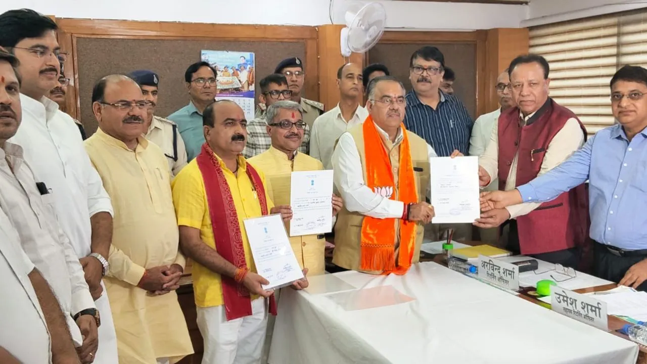 The Returning Officer handing over certificates of victory to the three BJP Rajya Sabha candidates.